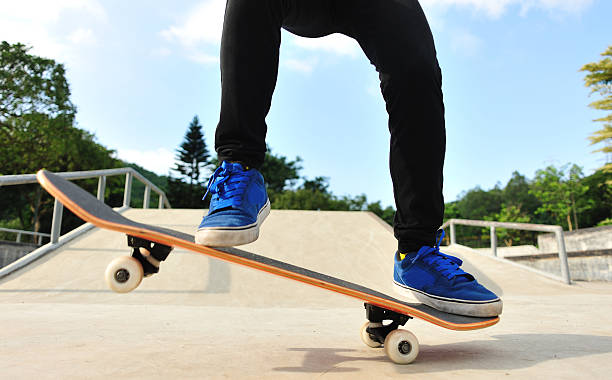 istock skateboarder jump at skatepark 497375163