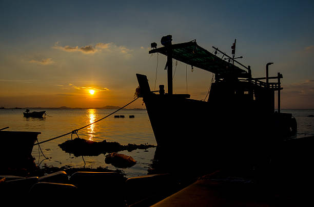 istock Silhouette of ship with sunset sky at sea 497379122