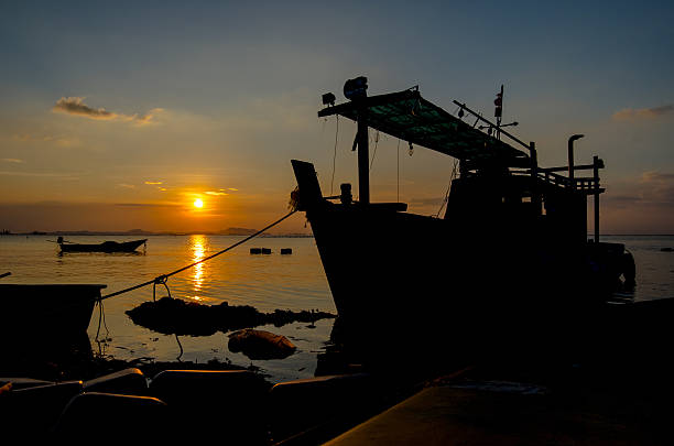istock Silhouette of ship with sunset sky at sea 497379438