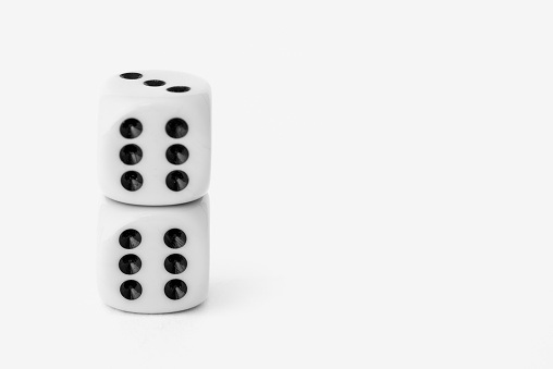 Stack of two die (dice) showing the lucky number six.  With copy space