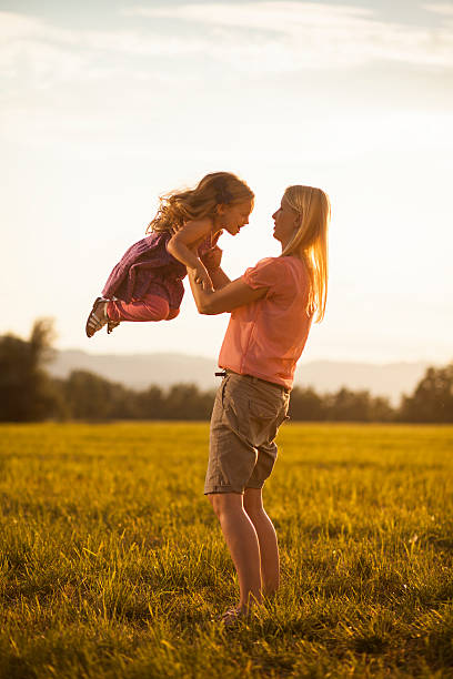 istock Mother and her daughter in the evening sun 497381614