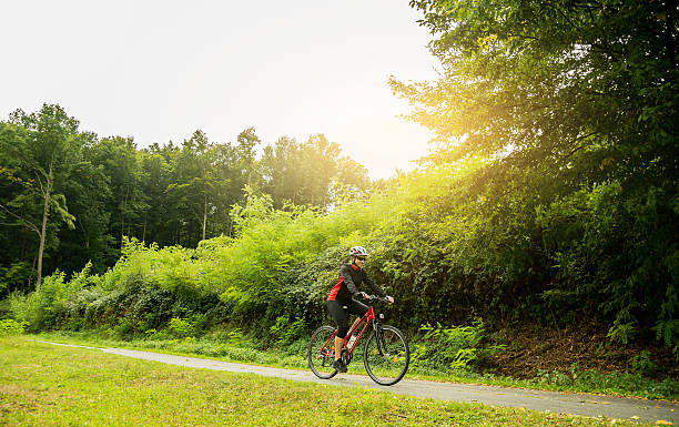 istock Young woman riding a bike 497383644