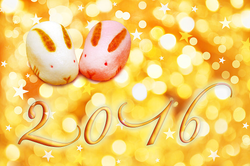 2016 japanese greeting card with rabbit shaped pastries and golden background