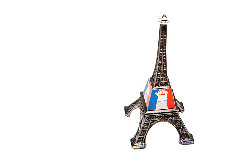 Replica of the Eiffel Tower in Paris with white background.