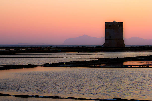sunset over the salt pans of Trapani with former watchtower