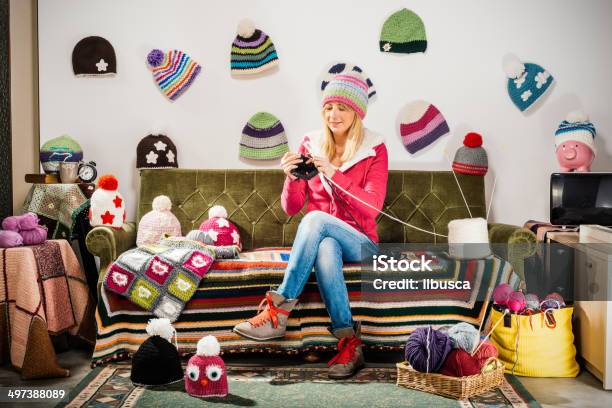 Young Woman Knitter Portrait On Couch With Winter Hats Stock Photo - Download Image Now