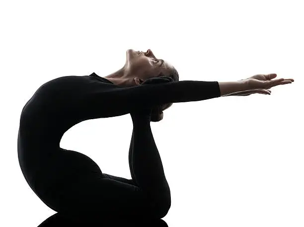 one woman contortionist practicing gymnastic yoga in silhouette on white background