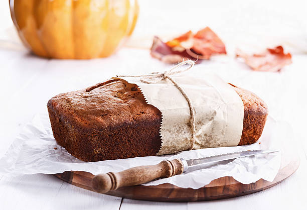 Pumpkin bread loaf over white wooden background stock photo