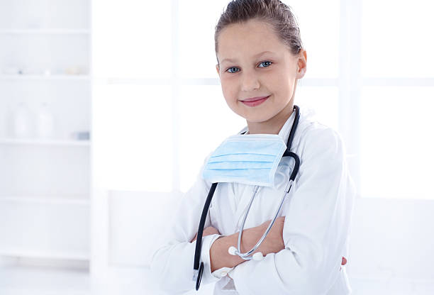 istock Cute little doctor smiling and looking at camera. 497390316