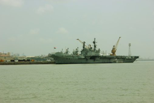 Mumbai, India - June 3, 2014: INS Viraat (R22) visits Mumbai port in Mumbai, India. INS Viraat (R22) is a Centaur-class aircraft carrier in service with the Indian Navy. INS Viraat is the flagship of the Indian Navy, the oldest carrier in service and one of three aircraft carriers based in the Indian Ocean Region.