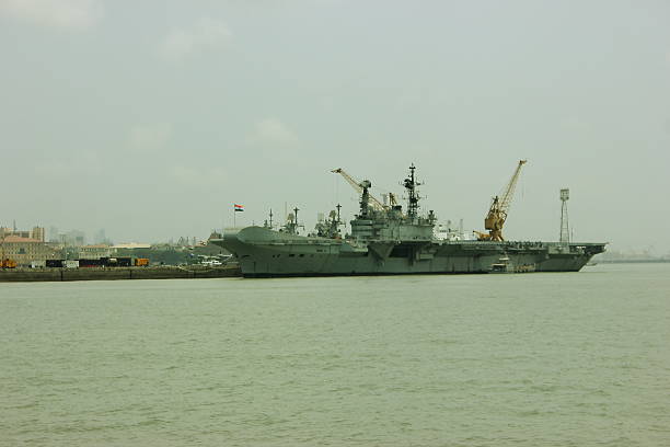 INS Viraat (R22) - Aircraft carrier of Indian Navy Mumbai, India - June 3, 2014: INS Viraat (R22) visits Mumbai port in Mumbai, India. INS Viraat (R22) is a Centaur-class aircraft carrier in service with the Indian Navy. INS Viraat is the flagship of the Indian Navy, the oldest carrier in service and one of three aircraft carriers based in the Indian Ocean Region. indian navy stock pictures, royalty-free photos & images