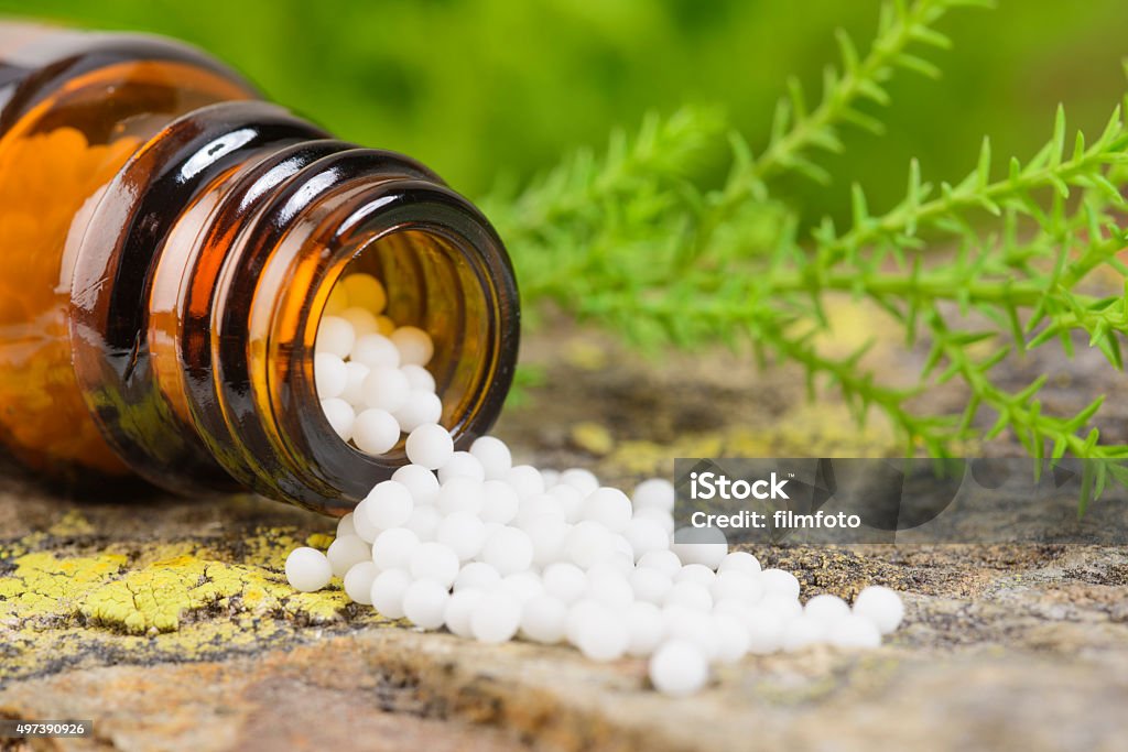 alternative medicine with herbal pills alternative medicine with homeopathic globules Homeopathic Medicine Stock Photo