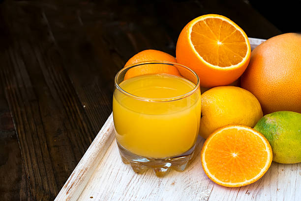 istock Fresh orange juice on wooden table 497390932