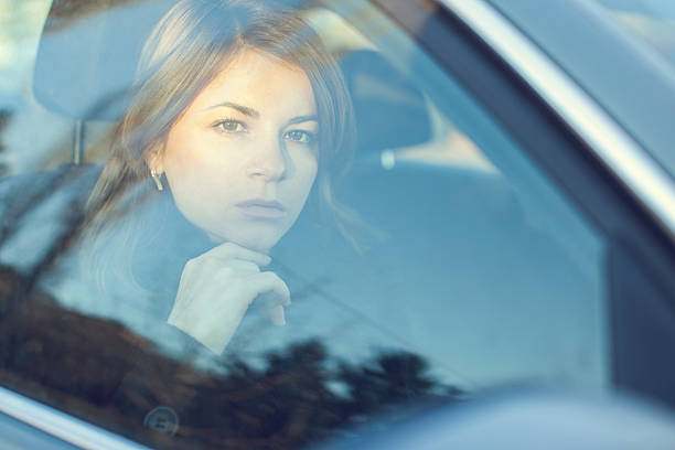 istock Serious young woman in a car thinking. 497391118