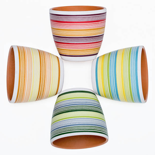 istock Four flower pot in bright colored stripes. 497391701