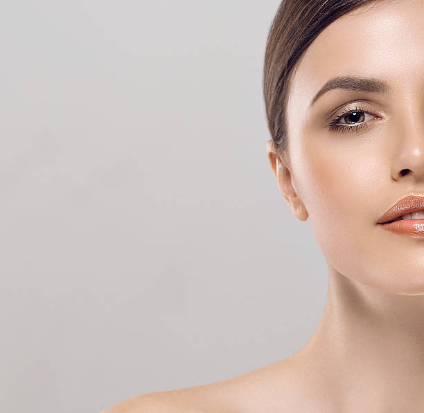 istock Beautiful woman face close up studio white sexy lips 497392460