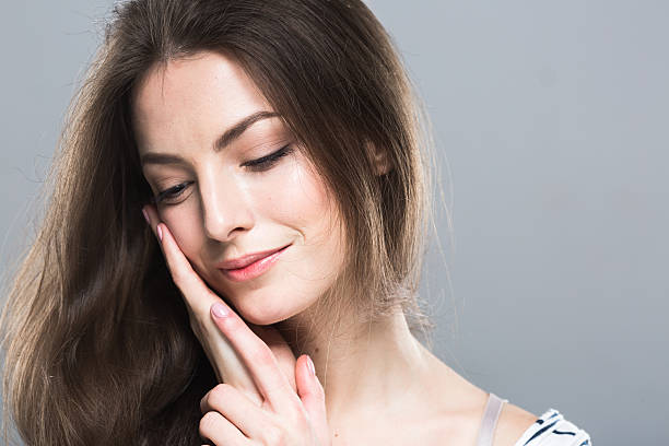 istock Beautiful woman portrait face close up studio grey background 497392798