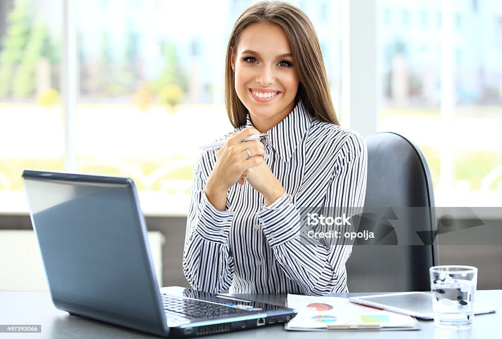 Portrait of a young business woman using laptop at office Cut Out Stock Photo