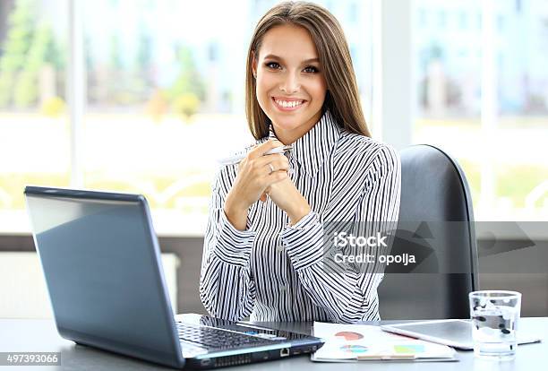 Portrait Of A Young Business Woman Using Laptop At Office Stock Photo - Download Image Now