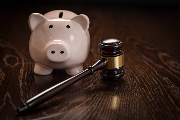 istock Gavel and Piggy Bank on Table 497393429