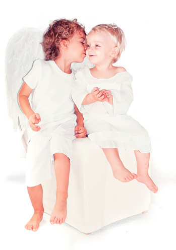 One angel whispering to another angel. Isolated on white