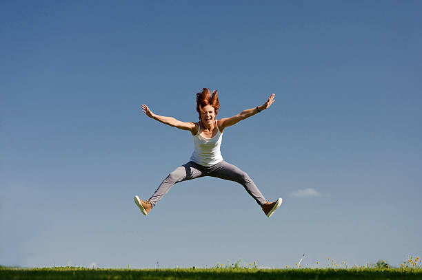 istock Young woman jumping outside 497409391