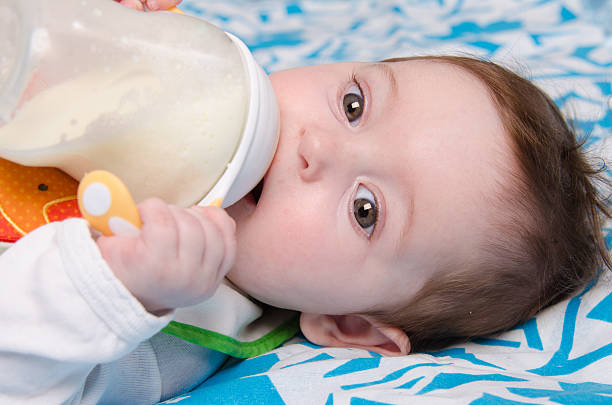 istock Baby drinking milk from a bottle 497410045