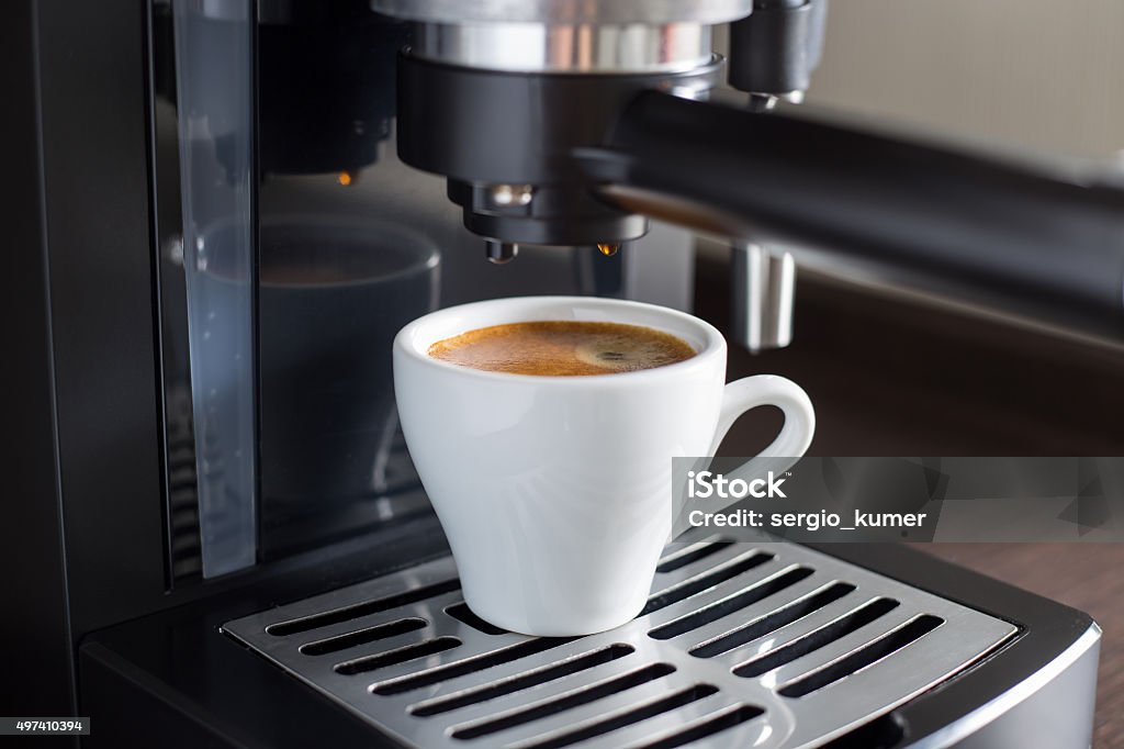 Brewing tasty espresso with coffee machine. Brewing tasty espresso with coffee machine. Preparing coffee at home or work 2015 Stock Photo