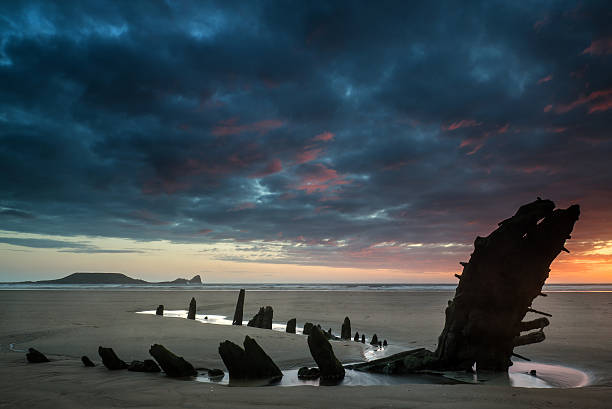 istock Beautiful dramatic sunset landscape over shipwreck on Rhosilli B 497410759