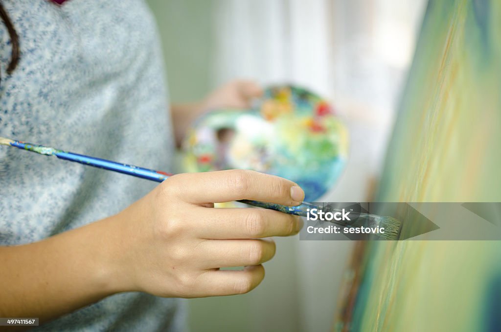 Artist working on a painting Woman painting Easel Stock Photo