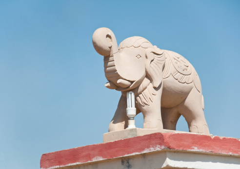 indian elephant made of sandstone on the roof of a house in rajasthan