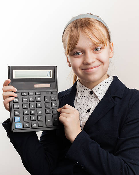 istock Little blond smiling schoolgirl with calculator above white 497412113