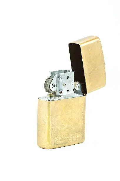 Brass metal zippo lighter isolated on white background.