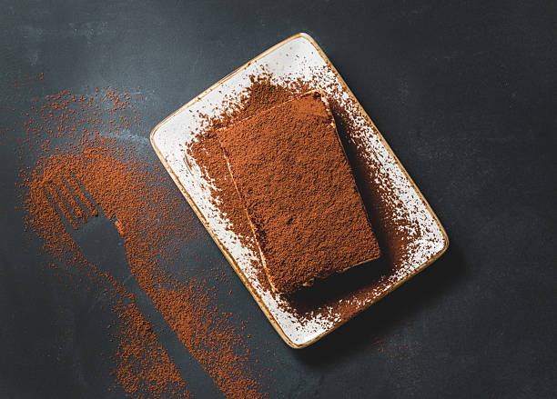 istock Tasty tiramisu cake on black background, top view 497412900