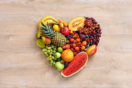 Heart symbol / studio photography of heart made from different fruits - on white background. High resolution product.