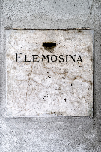 text charity on marble on the wall of a Church