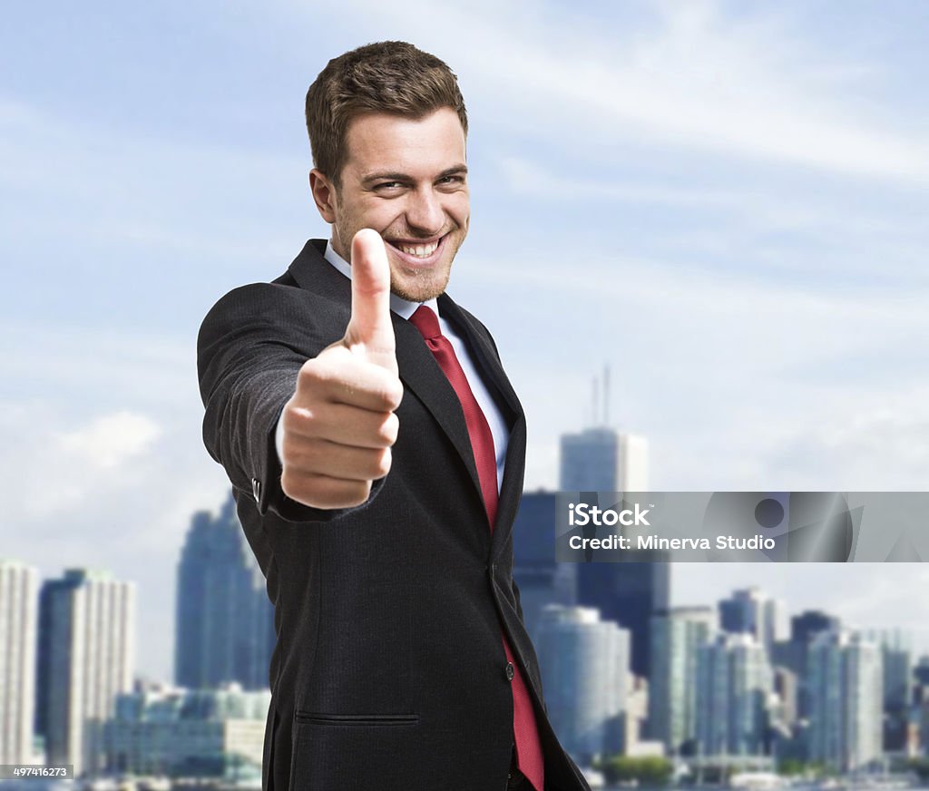 Thumbs up Portrait of a smiling businessman giving thumbs up Adult Stock Photo