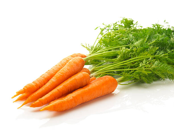 fresh carrots isolated a bunch of fresh carrots isolated on a white background pile of carrots stock pictures, royalty-free photos & images