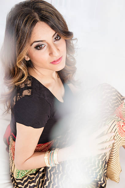 istock Beautiful young woman sitting on sofa 497419342