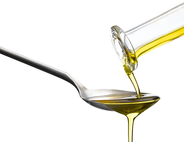 istock Olive Oil pouring over tablespoon 497429665