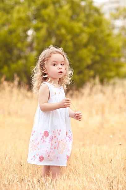istock Cute baby girl in meadow 497432233