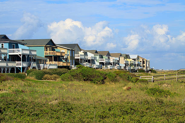 istock Row of beach houses on the sand dunes 497432965
