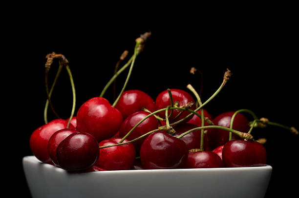 istock Bowl of Cherries on dark background 497433483