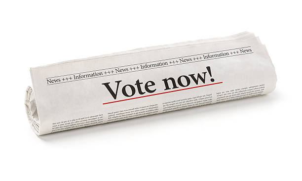 istock Rolled newspaper with the headline Vote now 497437844