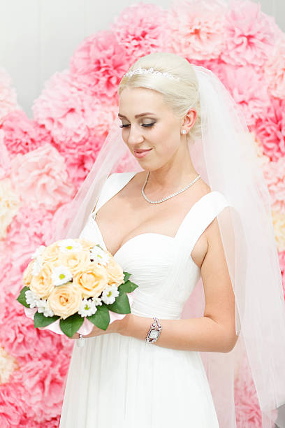 istock The bride in a white dress and bouquet 497439110