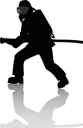 Silhouette of a firefighter in action