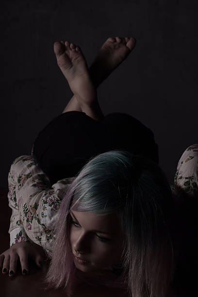 istock Girl with multi-coloured hair crawling on the table 497441298