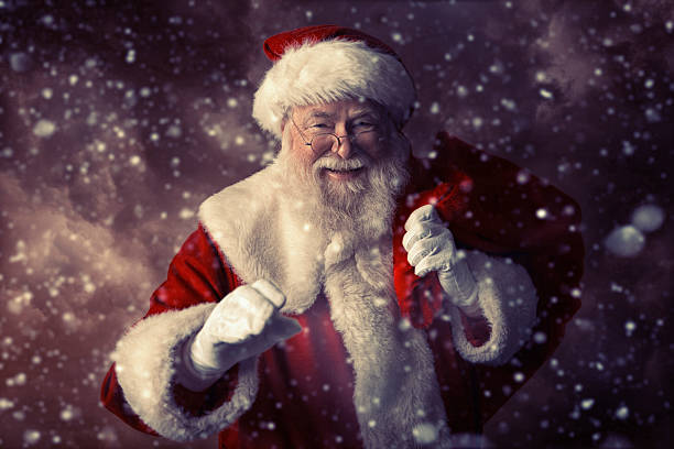 istock Santa Claus happy that it is snowing 497442018