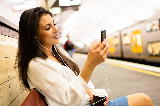 istock Young woman using a phone at train station in Sydney 497442036