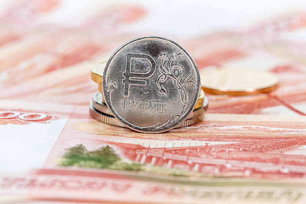 istock Russian currency, rouble: banknotes and coins close up 497442916